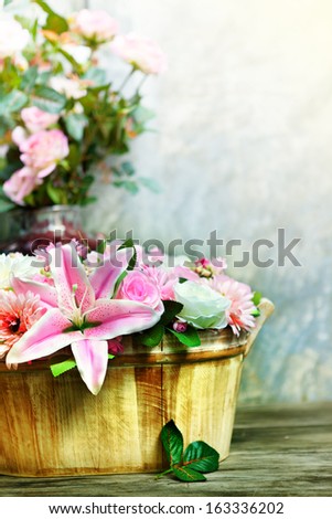 lily flower bouquet and roses decorated by arrangement in wood bucket vertical form use as  home decoration nature flora theme
