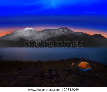 camping tent with rock and snow mountain scene use for natural adventure journey and heaven destination