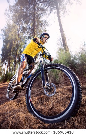 young man riding mountain bike mtb in jungle track use for sport  extreme adventure  healthy  and holiday activities life style
