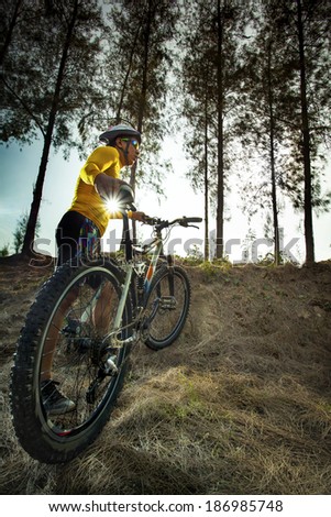 young man and mountain bike on jungle track use for sport activities and extreme hobby
