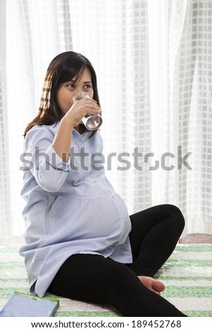 asian woman pregnant ,pregnancy drinking fresh water in glass use for maternity health care