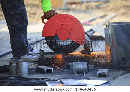 worker hand working by industry tool cutting steel with split fire use for industrial manufacturing theme