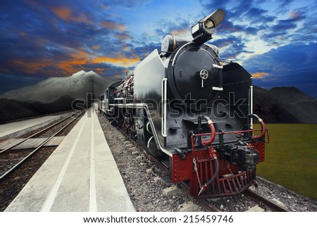 stream engine locomotive train on railways track with beautiful dusky sky and mountain scene