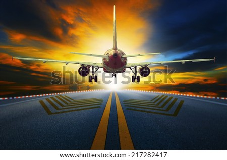 passenger jet plane preparing to take off from airport runways with motion blur against beautiful dusky sky