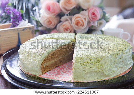 close up big pound of green tea cake sliced on table top