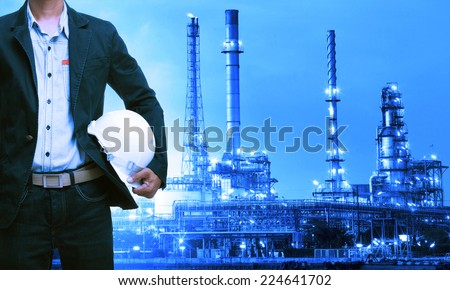 engineering man and safety helmet standing against oil refinery plant in heavy petrochemical industry estate