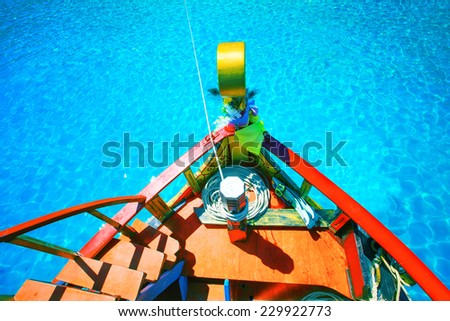 colorful of wood boat against beautiful clear blue sea water with clear water reflection