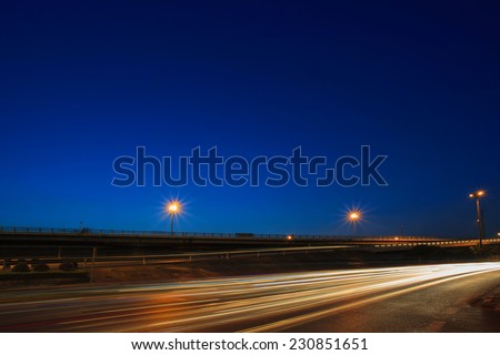 lighting of vehicle driving on asphalt road against beautiful blue dusky sky in evening use as land transport background ,backdrop