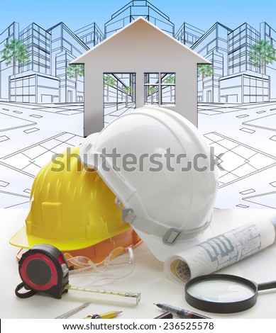 engineering working table writing tool ,equipment ,and safety helmet against two point perspective of building exterior