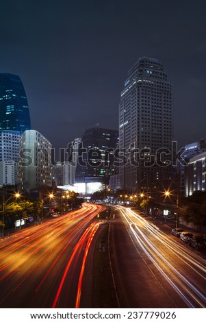 vehicle lighting on urban road and building against night scene sky of bangkok thailand