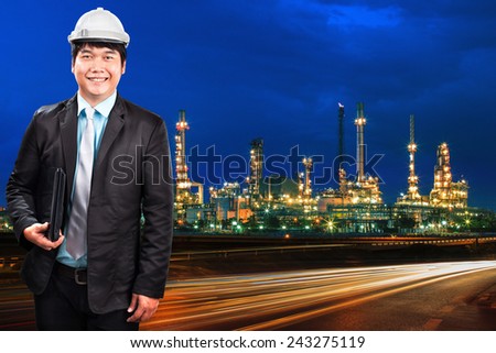 engineering man and oil refinery plant against beautiful blue dusky sky and vehicle lighting on asphalt road use as land transport and oil power industry topic background