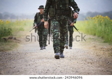 soldier with rifle gun  long range  patrolling on field