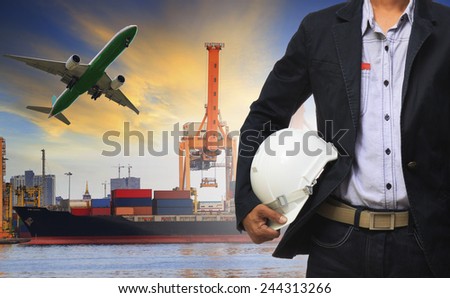 manager man holding safety helmet standing against ship and container on shipping port and cargo plane flying above use for freight and logistic transport industry
