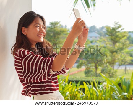 portrait of beautiful woman take a photo, selfie by mobile phone  use for modern digital life and people activities