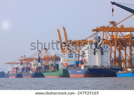 commercial container ship on port use for water transport and ship yard crane loading goods