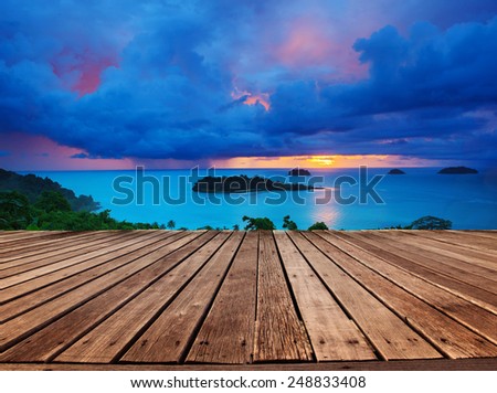 top wood panel terrace with beautiful dramatic sky of sun set and rainy cloud scape