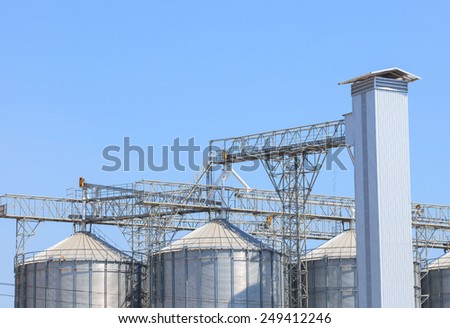 exterior structure of new agriculture silo building against blue sky