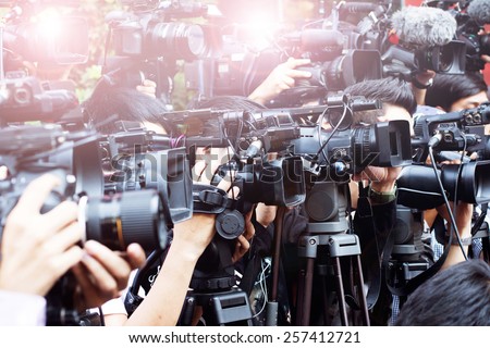press and media camera ,video photographer on duty in public news coverage event for reporter and mass media communication