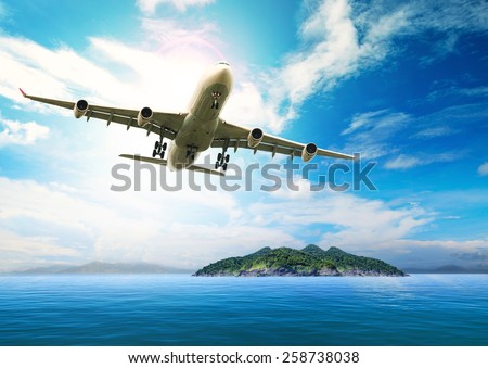 passenger plane flying over beautiful blue ocean and island in purity destination sea beach use for summer holiday vacation traveling