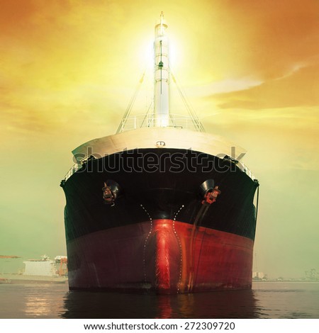 front view of commercial ship floating in port against sun light over sky