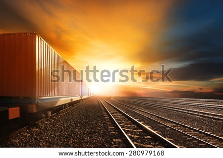 industry container trains running on railways track against beautiful sun set sky use for land transport and logistic business