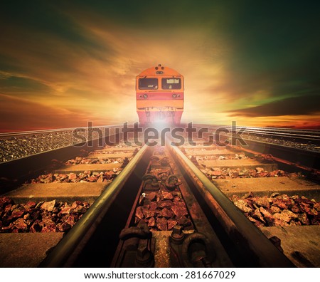 trains on junction of railways track in trains station against beautiful light of sun set sky use for land transport and logistic industry background ,backdrop,copy space theme