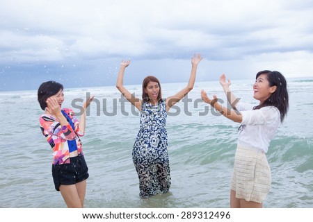 portrait group of young asain woman friend playing with happy emotion on sea beach used for people relaxing emotion ,and enjoy vacation summer holiday