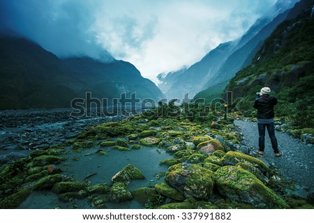 traveling man take a photograph in franz josef glacier important traveler destination in south island new zealand