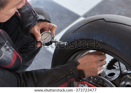man motorcycle tire manual air pressure testing before traveling trip for safety riding vehicle