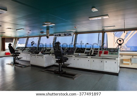wheelhouse control board of modern industry ship approaching to harbor