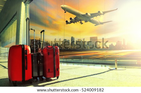 traveling luggage in airport terminal building and jet plane flying over urban scene