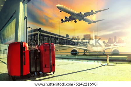 traveling luggage in airport terminal building and jet plane flying over sky