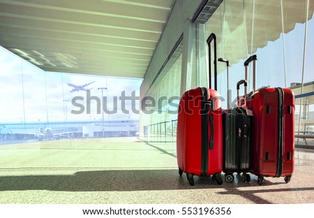 stack of traveling luggage in airport terminal and passenger plane flying for air transport and traveling theme