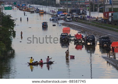 AYUTTHAYA THAILAND - OCT 14 : Phaholyothin Road is close by flood water at Wangnoi District ,victims of flood are on the road and make many of activity on Oct14,2011 in Ayutthaya Thailand