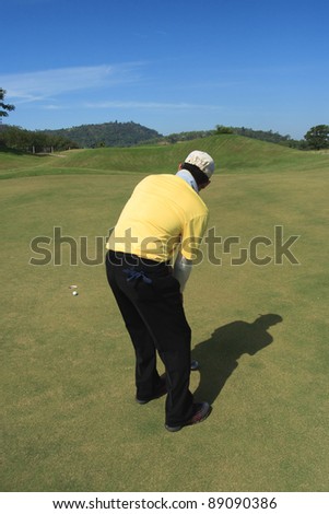 man push golf on green