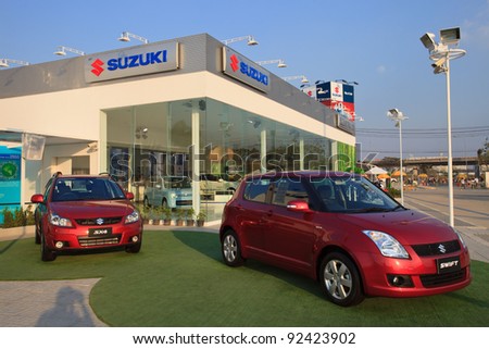 BANGKOK - JANUARY 10: new Suzuki Swift car display in front of Suzuki booth at BOI FAIR 2011 on January 10, 2012 in Bangkok, Thailand ,