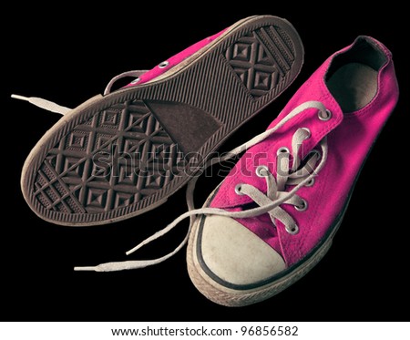 old pink shoes isolated black background