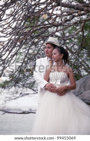asian man and women in wedding suit hug with love emotion
