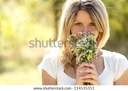 daisy flowers field holds a young woman in nature