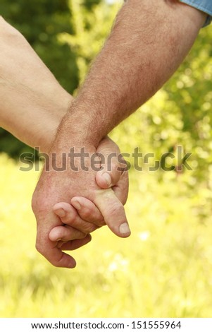 a two hands of an elderly couple