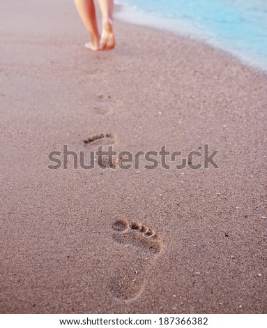 a Women\'s footprints in the sand