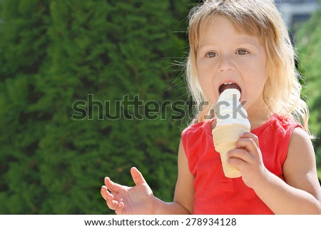 beautiful little girl with ice cream on the nature