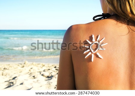 from sun cream on the female back on the seaside