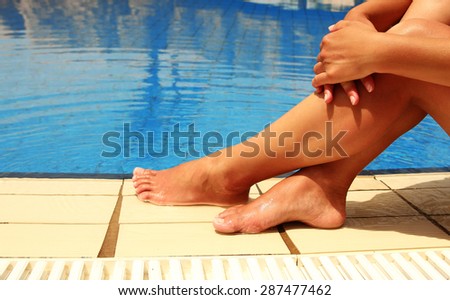 a female legs in the pool water pool