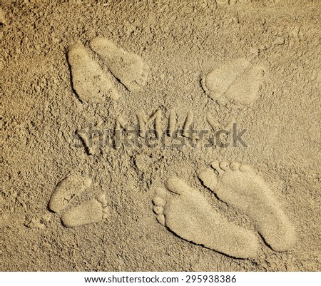 a family footprints in the sand on the beach