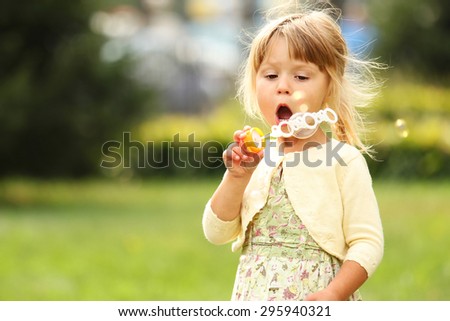 a little girl with soap bubbles