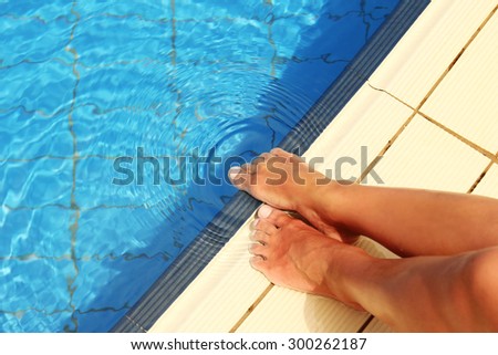 a female legs in the pool water pool,