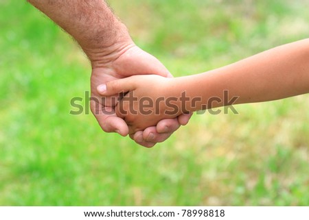 the father gives the child\'s hand