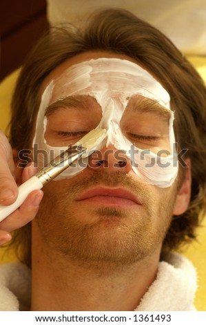 A man receives a facial treatment in the spa
