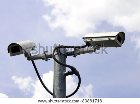 security cameras in front of blue sky